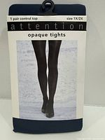 Front of packaged Attention opaque tights showing size 1X/2X and product image