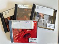 Front view of four CD jewel cases with library labels visible