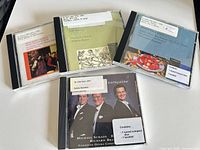 Front view of 4 jewel cases showing cover art and library stickers