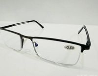 front three-quarter view of black metal reading glasses showing +3.50 label and rectangular lenses