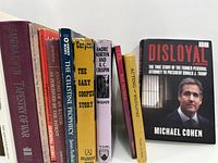 Row of ten assorted books showing spines and titles