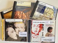 Front view of all five CD jewel cases showing titles and library labels