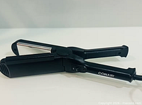 Straightener open showing glass plates and hinge