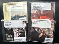 Front view of four compact discs showing cover art and library labels