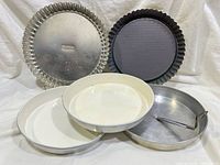 Front view of all five pans showing types and colours