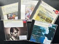 Five jewel-case CDs with library labels displayed front side
