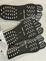 Three pairs black five-toe foot pads with white grip dots in packaging