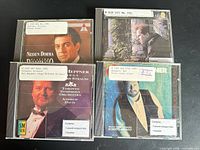 All four CDs laid out showing front covers with library labels