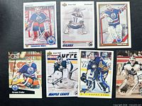 Seven Grant Fuhr hockey cards laid out on black surface