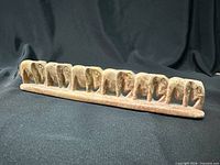 Full view of soapstone elephant sculpture showing all elephants and marbled coloring