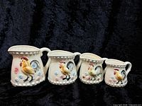 Front view of full set of four rooster measuring cups