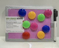 Front view of packaged mini pink dry erase board with attached marker and magnets