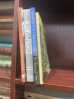 Spines of four of the five paperback books