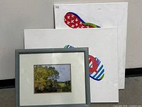 Group shot of framed landscape print and two flip-flop canvases