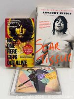 Front covers of two paperbacks and front of sealed CD