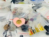 Mixed buttons in bags showing range of materials and colours