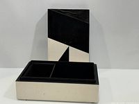 Box open showing interior compartments and geometric lid design