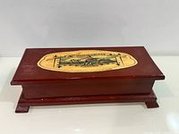 Top view of burgundy wooden Montecristo box showing logo