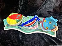 Top view of tray with three fish bowls showing multicolor glaze