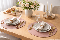 Tablescape showing two dusty pink round placemats under place settings