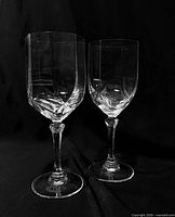 Two crystal wine glasses standing upright showing overall design