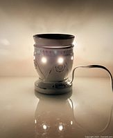 Warmer plugged in, illuminated, showing overall design and function