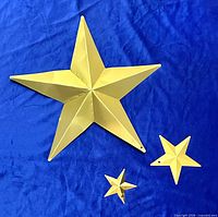 Front view of all three gold metal stars on blue background
