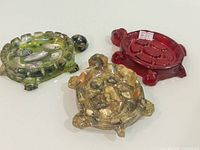 Front view of all three turtle ashtrays showing colors and designs