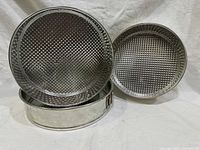 all three springform pans showing textured bases and graduated sizing