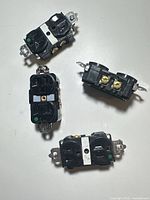 Four black commercial-grade duplex outlets front view