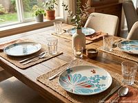 Plates in use on dining table with place settings