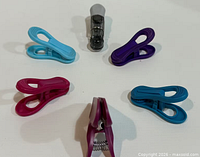 Top view of six assorted clothespins arranged in a circle