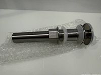 Complete stainless steel sink drain assembly on bubble wrap