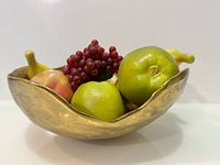 Top view of wavy-rim brass bowl filled to show scale