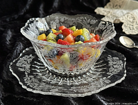 bowl filled with fruit on underplate showing etching detail