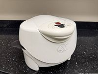 Front view closed showing white exterior and logo