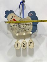 Front view of chicken wall sign with ruler for scale