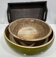 Two nested wooden bowls inside dark wooden tray