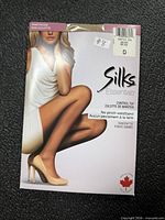 Front of Silks Couture pantyhose package showing brand, control top, size D sticker