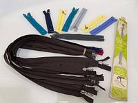 Group showing all zippers including brown bundle, assorted short zippers, Unique packaging
