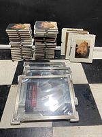 Stacks of 5x7 and 8x10 clip frames plus shrink-wrapped 11x14 frames
