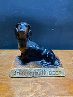 Full view of chalkware dachshund figurine on base showing overall form and size