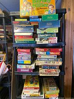 Full shelf view showing majority of board games stacked on three tiers