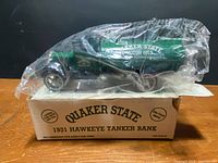 Box top showing Quaker State 1931 Hawkeye Tanker Bank with truck in bag