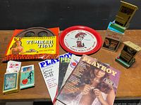 Overview of all items including magazines, games, bar tray, playing cards, novelty banks