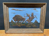 Frontal view of framed copper relief artwork