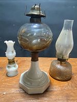 All three oil lamps grouped on table