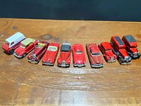 Nine red die-cast vehicles lined up