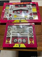 Two boxed Wisdom construction sets showing front packaging and contents