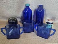 Group shot of all seven cobalt blue glass items